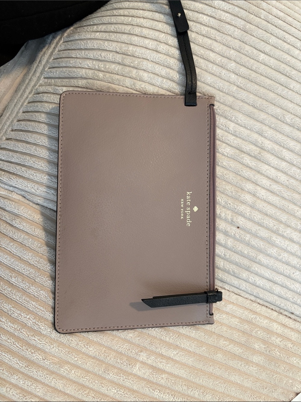 kate spade mauve leather wristlet with black strap
